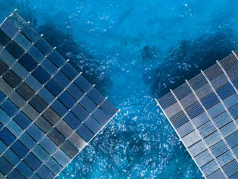 Aerial view of the SolarSea floating solar power plant with blue panels on turquoise ocean water Dharavandhoo Baa Atoll Maldives. Aerial view of the SolarSea floating solar power plant with blue panels on turquoise ocean water Dharavandhoo Baa Atoll Maldives.