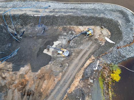 Oulu North Ostrobothnia Finland 18 September 2026 Aerial view of construction site at waterfront with two excavators working on gravel and dirt featuring blue water pipes. Oulu North Ostrobothnia Finland 18 September 2026 Aerial view of construction site at waterfront with two excavators working on gravel and dirt featuring blue water pipes.