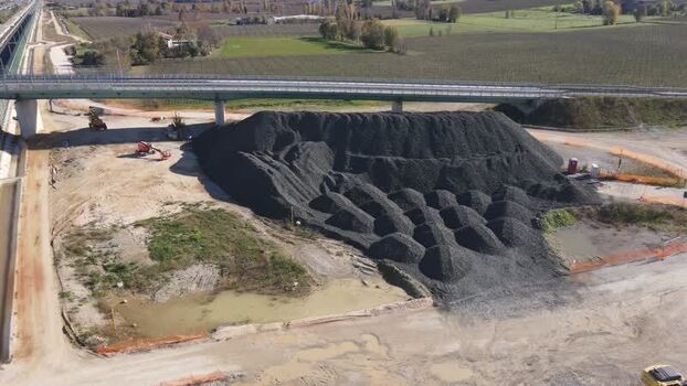Aerial view of a construction site and gravel pile Italy.