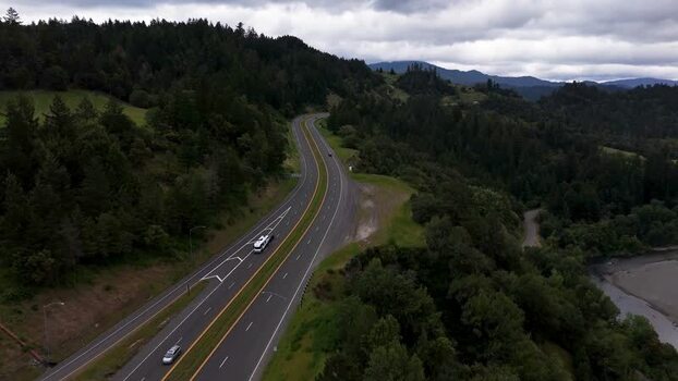 Aerial view of a winding highway through dense forest United States. Aerial view of a winding highway through dense forest United States.