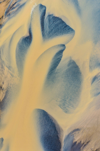 Aerial view of the intricate sediment patterns and glacial meltwater channels of Drangajokull glacier in Isafjordur Isafjardarbaer Iceland. Aerial view of the intricate sediment patterns and glacial meltwater channels of Drangajokull glacier in Isafjordur Isafjardarbaer Iceland.