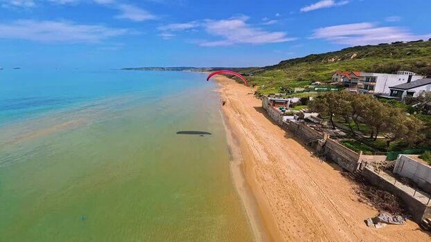 Aerial view of a red paramotor over Kilyos Beach Turkey. Aerial view of a red paramotor over Kilyos Beach Turkey.