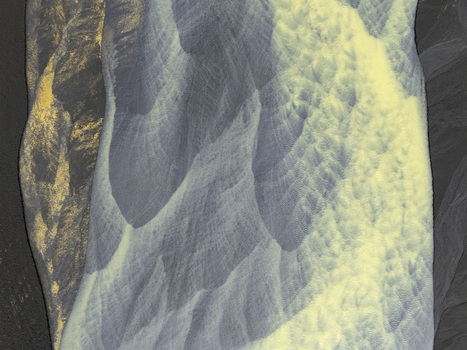 Aerial view of the intricate patterns of a braided glacial river with silvery blue water flowing over dark volcanic sand and yellow sediment in Hallgeirseyjarvegur Rangarthing eystra Iceland. Aerial view of the intricate patterns of a braided glacial river with silvery blue water flowing over dark volcanic sand and yellow sediment in Hallgeirseyjarvegur Rangarthing eystra Iceland.
