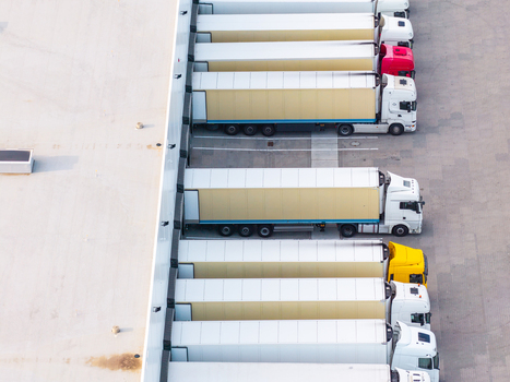 Aerial view of Gdansk Kowale Distribution Centre with semi trucks parked at loading docks showing trailers asphalt yard and warehouse roof in Kowale Pomeranian Voivodeship Poland. Aerial view of Gdansk Kowale Distribution Centre with semi trucks parked at loading docks showing trailers asphalt yard and warehouse roof in Kowale Pomeranian Voivodeship Poland.