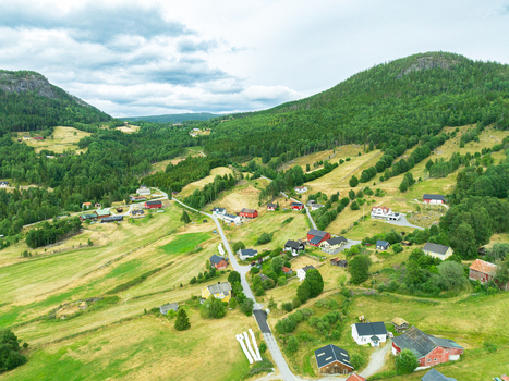 Aerial view of the rural village of Araksbo nestled in the lush green hills and valleys of Araksbo Agder Norway.