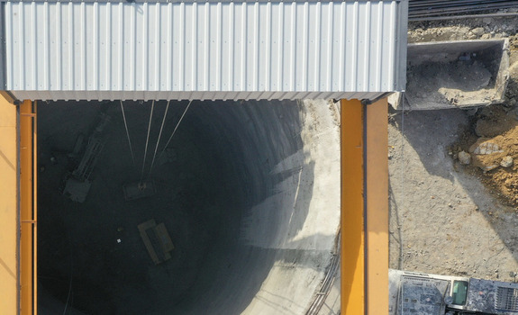 Aerial view of a deep circular construction shaft with a gantry crane and excavation equipment at a building site in Avcilar Istanbul Turkiye. Aerial view of a deep circular construction shaft with a gantry crane and excavation equipment at a building site in Avcilar Istanbul Turkiye.