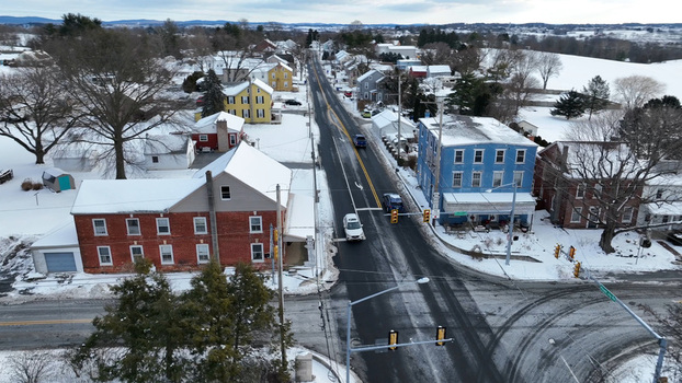 Aerial view of Sporting Hill during winter with snow covered roads historic brick and blue buildings and bare trees under a cloudy sky Hampden Township Pennsylvania United States. Aerial view of Sporting Hill during winter with snow covered roads historic brick and blue buildings and bare trees under a cloudy sky Hampden Township Pennsylvania United States.