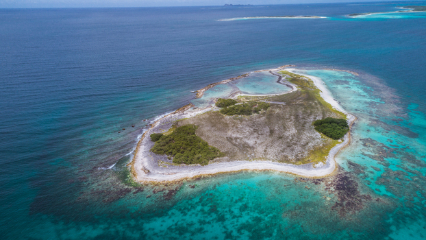 Aerial view of Los Roques archipelago with white sand beaches lush green vegetation and vibrant turquoise coral reefs in the Caribbean sea Los Roques Dependencias Federale Venezuela. Aerial view of Los Roques archipelago with white sand beaches lush green vegetation and vibrant turquoise coral reefs in the Caribbean sea Los Roques Dependencias Federale Venezuela.