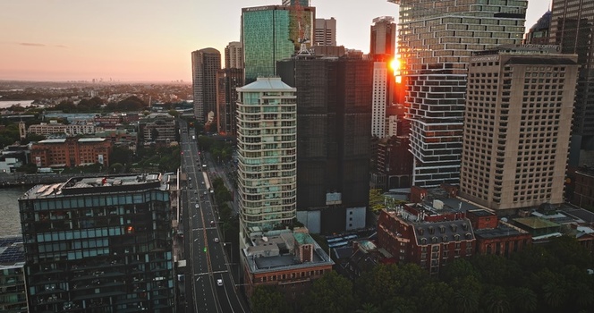 Aerial view of the Sydney skyline at sunset with modern skyscrapers urban streets and lush greenery in Sydney New South Wales Australia. Aerial view of the Sydney skyline at sunset with modern skyscrapers urban streets and lush greenery in Sydney New South Wales Australia.
