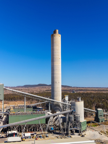 Aerial view of Millmerran Power Station with its tall concrete chimney industrial infrastructure and conveyor belts set in the rural landscape of Domville Queensland Australia. Aerial view of Millmerran Power Station with its tall concrete chimney industrial infrastructure and conveyor belts set in the rural landscape of Domville Queensland Australia.