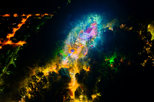 Aerial view of the Annafest festival at night with vibrant colorful lights illuminating the forest and crowds of people in Forchheim Bayern Germany. Aerial view of the Annafest festival at night with vibrant colorful lights illuminating the forest and crowds of people in Forchheim Bayern Germany.