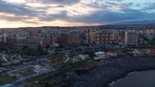 Aerial view of the coastal skyline at sunset in Catania Italy. Aerial view of the coastal skyline at sunset in Catania Italy.