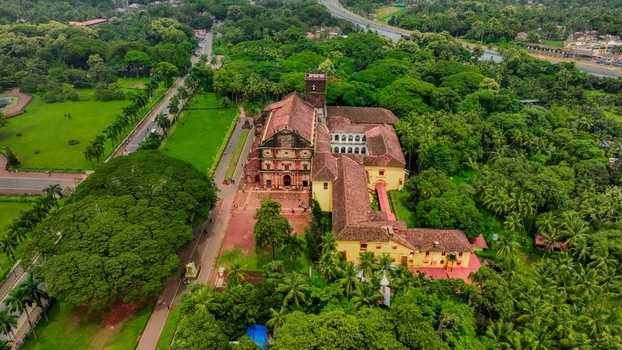 Aerial view of Church of St. Francis of Assisi surrounded by lush green trees and historic grounds in Old Goa Goa India. Aerial view of Church of St. Francis of Assisi surrounded by lush green trees and historic grounds in Old Goa Goa India.