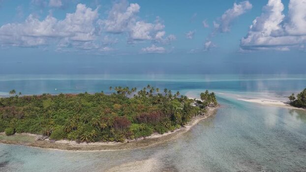 Aerial view of a tropical island and turquoise waters Maldives.