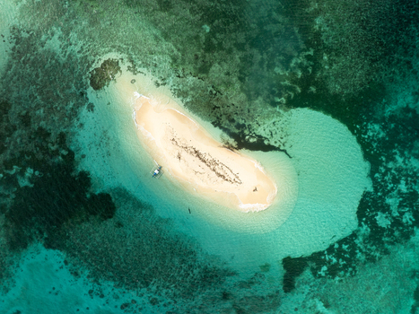 Aerial view of Naked Island surrounded by turquoise coral reefs and clear water in Siargao Philippines. Aerial view of Naked Island surrounded by turquoise coral reefs and clear water in Siargao Philippines.