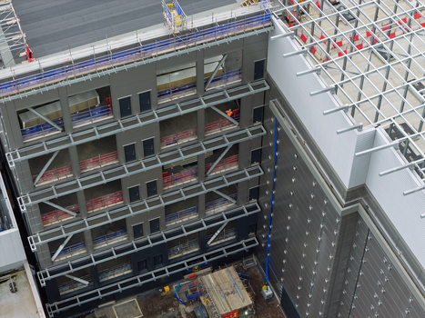 Aerial view of a modern data center under construction featuring a steel framework exterior cladding panels and scaffolding in the United Kingdom.