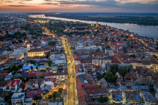 Aerial view of the historic Zemun district in Belgrade at sunset with the Danube river red tiled rooftops street lights and church in Belgrade City of Belgrade Serbia. Aerial view of the historic Zemun district in Belgrade at sunset with the Danube river red tiled rooftops street lights and church in Belgrade City of Belgrade Serbia.