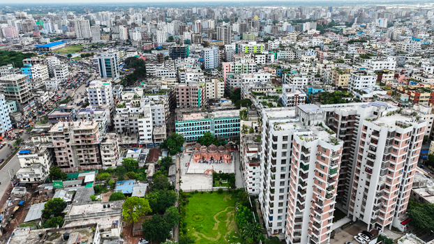 Aerial view of the dense urban landscape of Dhaka featuring a historic mosque surrounded by modern high rise buildings bustling streets and green spaces in Dhaka Dhaka Division Bangladesh. Aerial view of the dense urban landscape of Dhaka featuring a historic mosque surrounded by modern high rise buildings bustling streets and green spaces in Dhaka Dhaka Division Bangladesh.