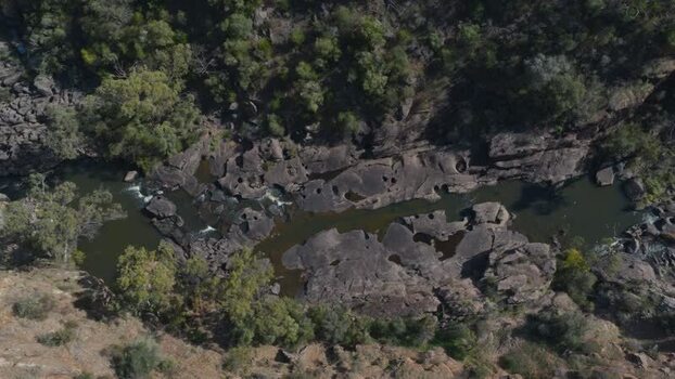 Aerial view of Onkaparinga Gorge with rocky riverbed and lush trees Australia.