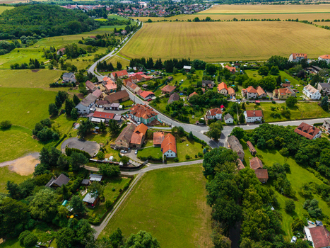 Aerial view of the village of Tocnik with its rural houses winding roads and surrounding green agricultural fields in Tocnik Stredocesky kraj Czechia. Aerial view of the village of Tocnik with its rural houses winding roads and surrounding green agricultural fields in Tocnik Stredocesky kraj Czechia.