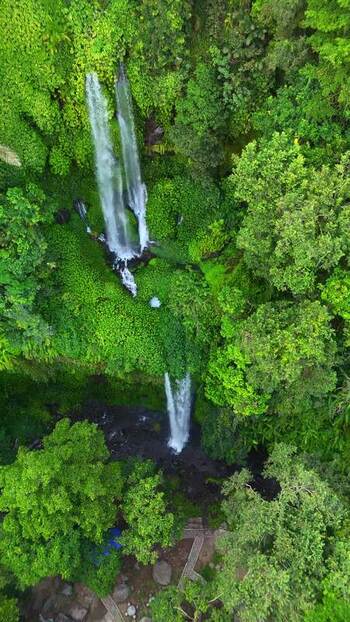 Aerial view of Sendang Gile Waterfall in lush jungle Indonesia. Aerial view of Sendang Gile Waterfall in lush jungle Indonesia.
