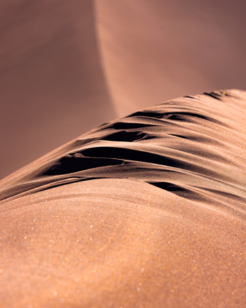 View of the wind sculpted ridges and fine textures of a sand dune in the Valley of the Moon San Pedro de Atacama Antofagasta Chile. View of the wind sculpted ridges and fine textures of a sand dune in the Valley of the Moon San Pedro de Atacama Antofagasta Chile.