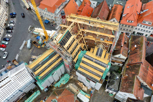 Aerial view of Rathaus Forchheim under renovation with scaffolding and a construction crane among historic red tiled rooftops Forchheim Bayern Germany. Aerial view of Rathaus Forchheim under renovation with scaffolding and a construction crane among historic red tiled rooftops Forchheim Bayern Germany.