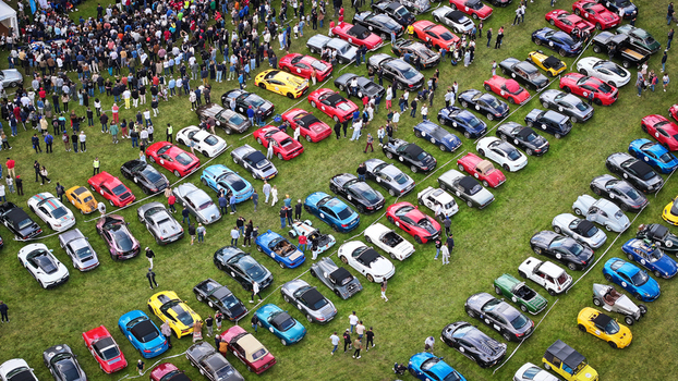 La Chapelle de Guinchay France 01 June 2024 Aerial view of a large gathering of colorful sports and classic cars parked in rows on a green field with a crowd of spectators. La Chapelle de Guinchay France 01 June 2024 Aerial view of a large gathering of colorful sports and classic cars parked in rows on a green field with a crowd of spectators.