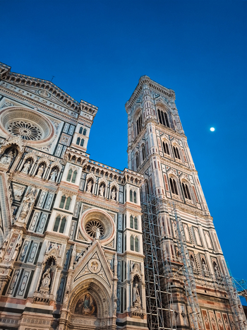 Florence Italy 26 April 2026 View of the intricate marble facade and Giotto s Campanile of the Florence Cathedral against a clear blue evening sky with a visible moon. Florence Italy 26 April 2026 View of the intricate marble facade and Giotto s Campanile of the Florence Cathedral against a clear blue evening sky with a visible moon.