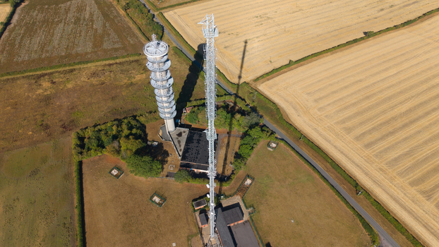 Aerial view of the Morborne Hill telecommunications transmitter towers standing in a rural landscape surrounded by agricultural fields in Morborne England United Kingdom. Aerial view of the Morborne Hill telecommunications transmitter towers standing in a rural landscape surrounded by agricultural fields in Morborne England United Kingdom.