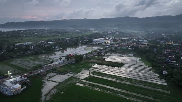 Aerial view of rice paddies and buildings in Pacitan Indonesia. Aerial view of rice paddies and buildings in Pacitan Indonesia.