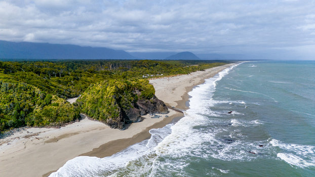Aerial view of where the rugged coastline meets dense forest the sea s teal hues contrast with the shore s sandy embrace Ship Creek Haast West Coast Region New Zealand. Aerial view of where the rugged coastline meets dense forest the sea s teal hues contrast with the shore s sandy embrace Ship Creek Haast West Coast Region New Zealand.