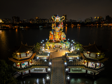 Aerial view of the illuminated Pei Chi Pavilion statue at Lotus Pond featuring traditional temple architecture and vibrant night lights in Kaohsiung Taiwan. Aerial view of the illuminated Pei Chi Pavilion statue at Lotus Pond featuring traditional temple architecture and vibrant night lights in Kaohsiung Taiwan.
