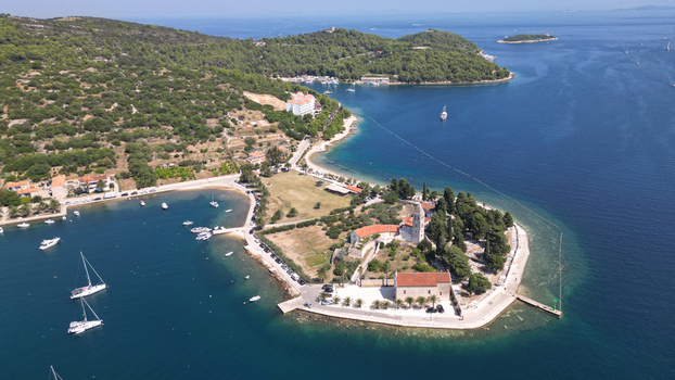 Aerial view of St. Jerome s Church and Monastery on a peninsula surrounded by turquoise waters and sailboats in Vis Split Dalmatia County Croatia. Aerial view of St. Jerome s Church and Monastery on a peninsula surrounded by turquoise waters and sailboats in Vis Split Dalmatia County Croatia.