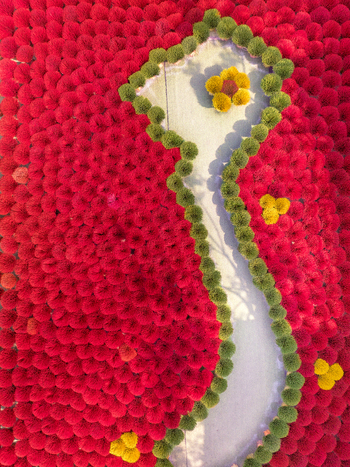 Aerial view of vibrant red green and yellow incense sticks arranged in intricate patterns during the drying process in Vietnam. Aerial view of vibrant red green and yellow incense sticks arranged in intricate patterns during the drying process in Vietnam.