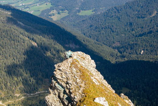 View of the jagged rocky peaks of the Dolomites overlooking a deep valley covered in dense pine forests under bright sunlight Rocca Pietore Veneto Italy. View of the jagged rocky peaks of the Dolomites overlooking a deep valley covered in dense pine forests under bright sunlight Rocca Pietore Veneto Italy.