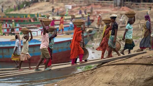 View of workers carrying sand baskets at Aminbazar Bangladesh. View of workers carrying sand baskets at Aminbazar Bangladesh.
