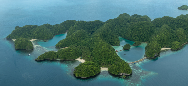 Aerial view of Bucas Grande islands featuring lush green vegetation turquoise lagoons and sandy beaches surrounded by coral reefs in Siargao Philippines. Aerial view of Bucas Grande islands featuring lush green vegetation turquoise lagoons and sandy beaches surrounded by coral reefs in Siargao Philippines.