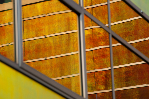 View of warm light reflecting and refracting through the geometric architectural window panes creating a mesmerizing display of color and form La Defense Netherlands. View of warm light reflecting and refracting through the geometric architectural window panes creating a mesmerizing display of color and form La Defense Netherlands.