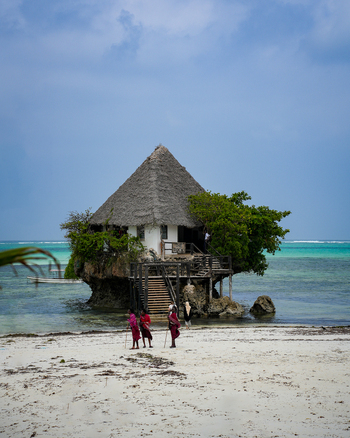 Paje Tanzania 25 January 2025 View of the iconic Rock Restaurant perched on a rock in the turquoise sea its thatched roof contrasting with the bright sky.