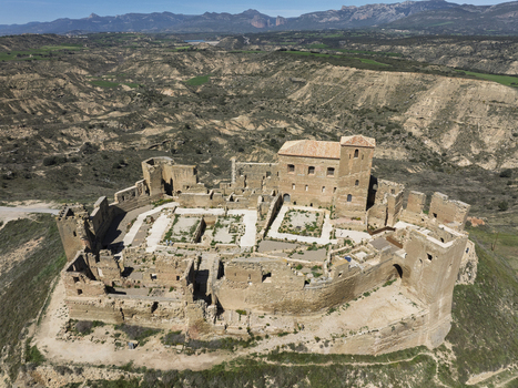Aerial view of Castle Montearagon a historic medieval fortress with stone walls and ruins situated on a hilltop overlooking the arid landscape of Quicena Aragon Spain.
