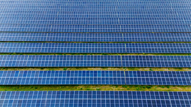 Aerial view of rows of blue solar panels in a large solar farm under bright daylight Sabac Vojvodina Serbia.