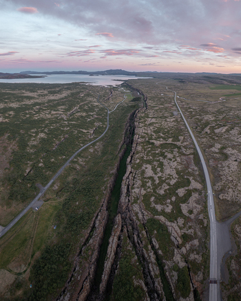 Aerial view of Thingvellir National Park showing the tectonic rift valley rugged volcanic terrain mossy lava fields and winding roads in Selfoss Blaskogabyggd Iceland. Aerial view of Thingvellir National Park showing the tectonic rift valley rugged volcanic terrain mossy lava fields and winding roads in Selfoss Blaskogabyggd Iceland.