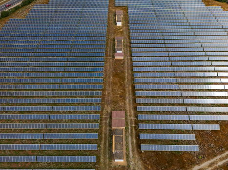 Aerial view of a large solar panel farm with rows of photovoltaic modules and utility buildings in Manacor Balearic Islands Spain. Aerial view of a large solar panel farm with rows of photovoltaic modules and utility buildings in Manacor Balearic Islands Spain.