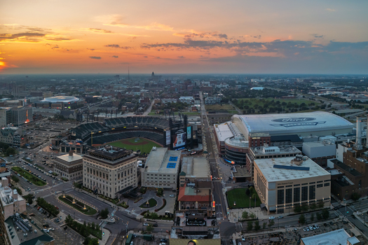 Detroit United States 04 August 2024 Aerial view of Comerica Park and Ford Field in downtown Detroit Michigan featuring urban architecture city streets and a sunset sky.
