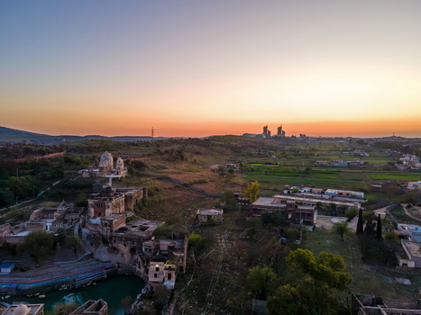 Aerial view of Katas Raj Temple Complex with its historic stone structures and sacred pond set against the rolling landscape of Punjab at sunset Katas Punjab Pakistan. Aerial view of Katas Raj Temple Complex with its historic stone structures and sacred pond set against the rolling landscape of Punjab at sunset Katas Punjab Pakistan.