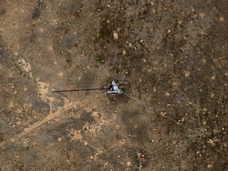Aerial view of a telecommunications tower standing in a dry field dotted with numerous small mounds in Thornton Colorado United States. Aerial view of a telecommunications tower standing in a dry field dotted with numerous small mounds in Thornton Colorado United States.