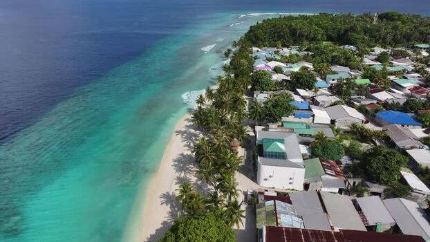 Aerial view of the tropical coastline and village of Maalhos Maldives. Aerial view of the tropical coastline and village of Maalhos Maldives.