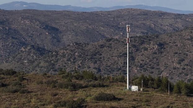 Aerial view of cell tower on hillside Portugal.