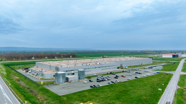Aerial view of the expansive industrial complex where silver silos gleam beneath a soft sky contrasting with the verdant fields Sremska Mitrovica Vojvodina Serbia. Aerial view of the expansive industrial complex where silver silos gleam beneath a soft sky contrasting with the verdant fields Sremska Mitrovica Vojvodina Serbia.